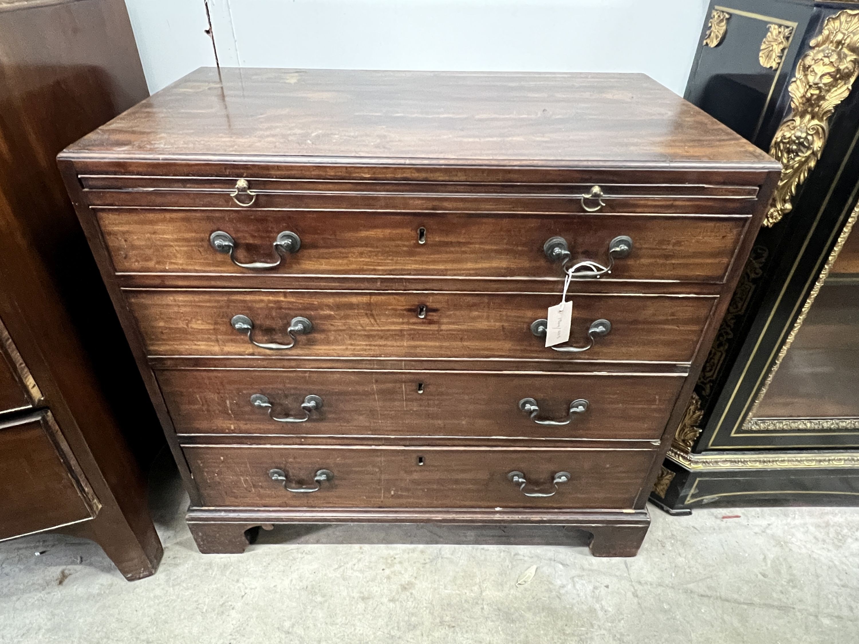 A Georgian mahogany straight front chest, fitted four graduated drawers and a slide, caddy top, brass handles and square bracket feet, width 84cm, depth 49cm, height 79cm